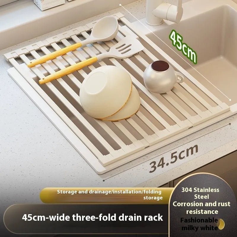 A milky white foldable stainless steel kitchen draining rack collapsed flat beside a kitchen sink.