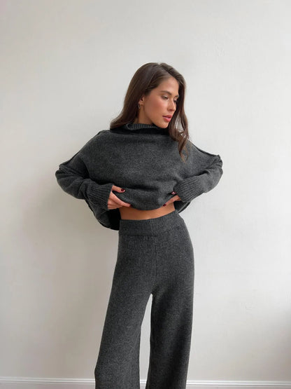 Women's acrylic side-slit sweater suit in dark grey, featuring a top and trousers for a coordinated two-piece set.