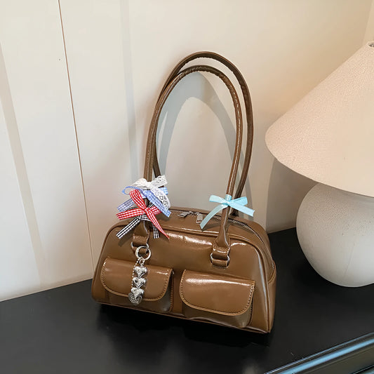 Brown retro women's pillow handbag with double shoulder straps and a flap closure.