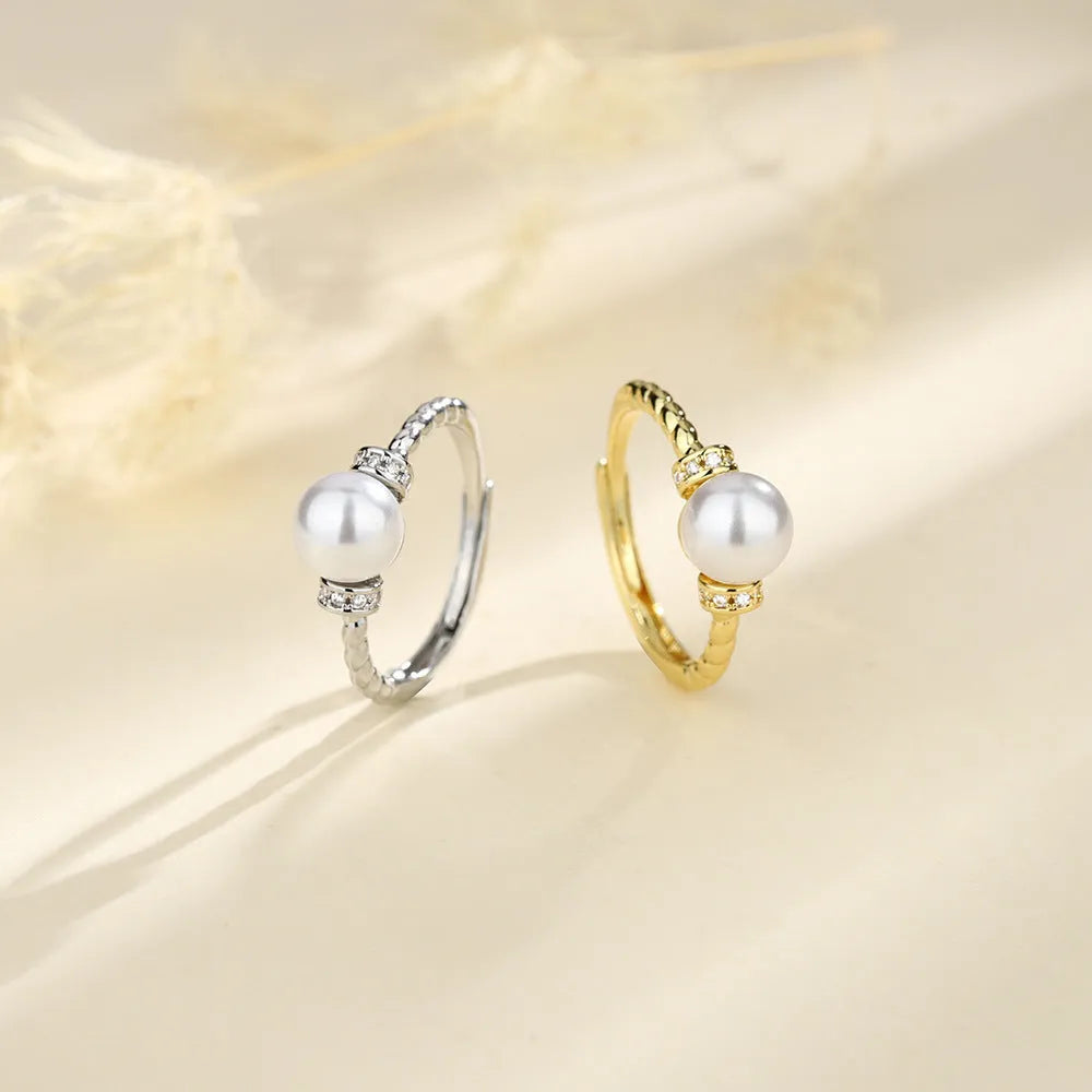 Adjustable copper ring with pearl inlay in geometric twist design, gold or silver finish