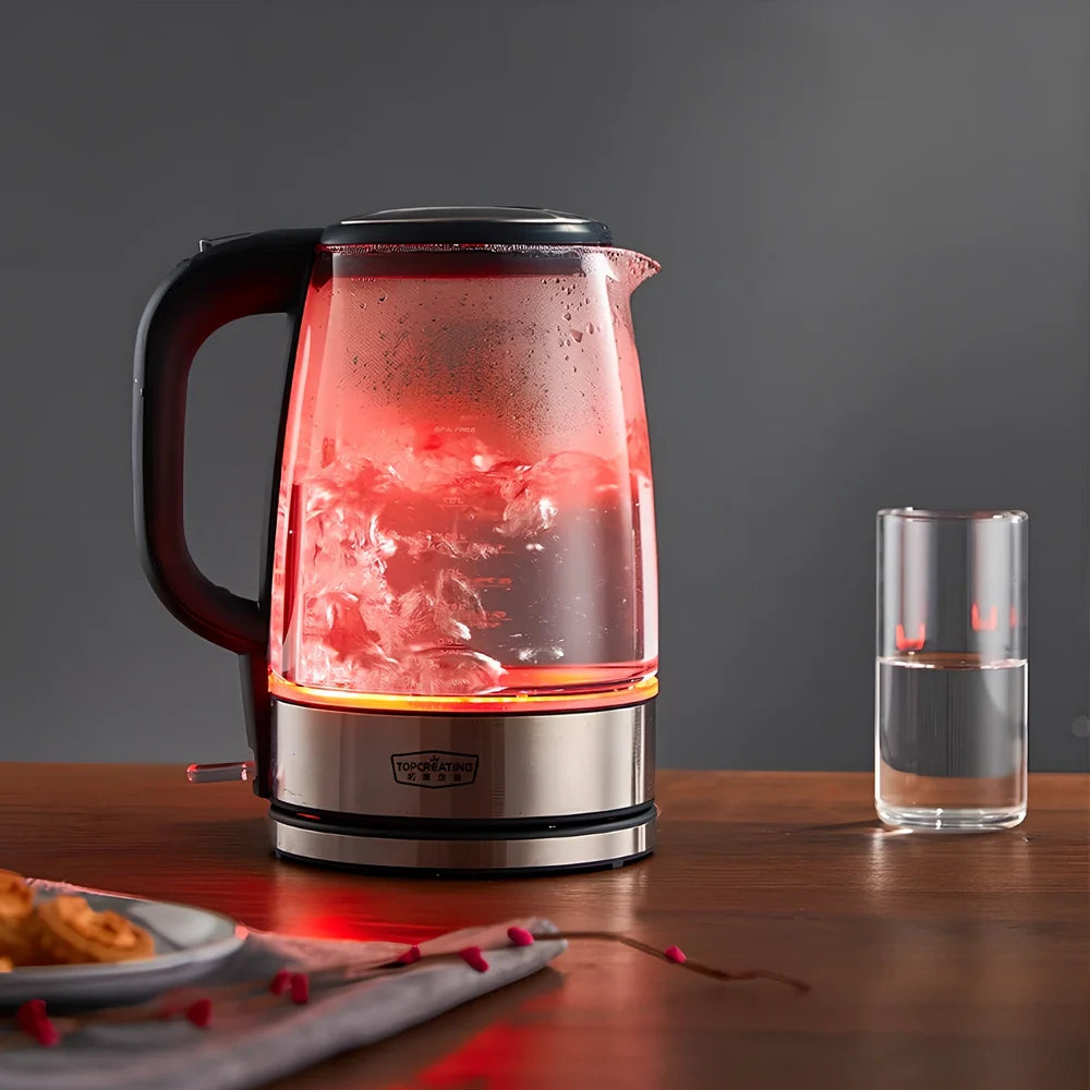 Transparent glass electric kettle showing water level scale and ergonomic handle