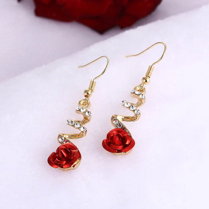 Ethnic red rose drop earrings with big rhinestones in rose gold spiral design