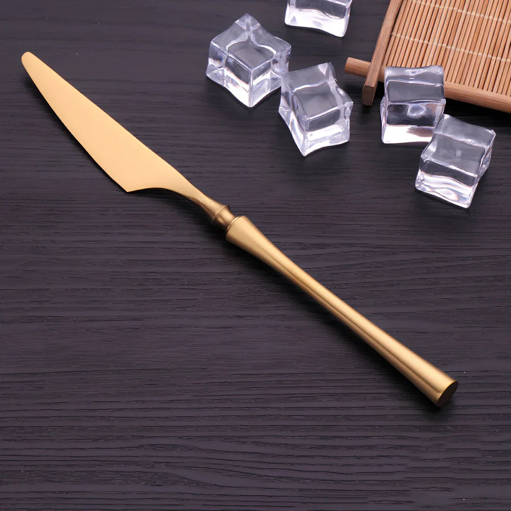 Four-piece stainless steel cutlery set showing main knife, fork, spoon, and teaspoon with mirror finish