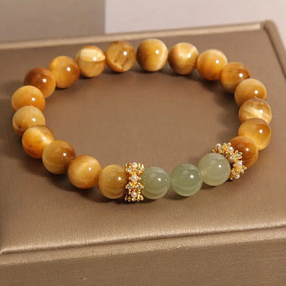 Natural yellow Tiger's Eye bracelet with Hetian jade elements and gold gourd charm on wrist