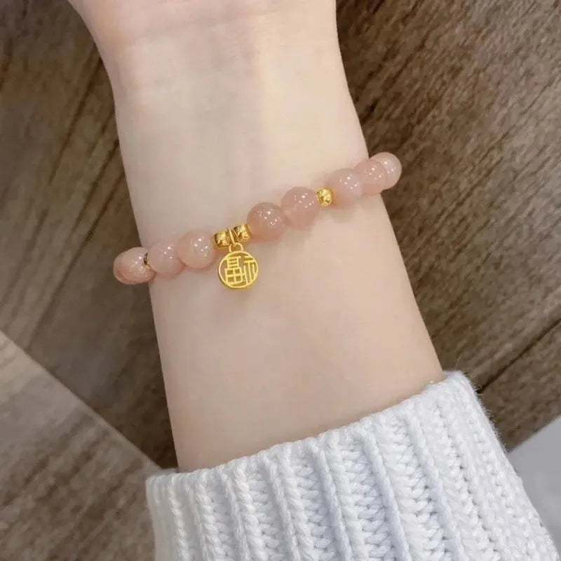 Chinese style glass bead bracelet with bamboo joint design on wrist.
