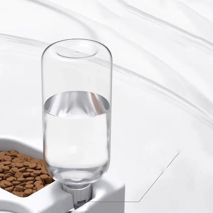 White plastic pet water fountain with pump for cats and dogs on a floor.