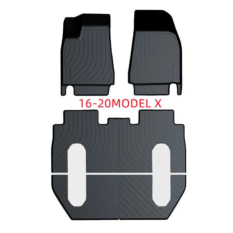 Black TPE rubber floor mats for Tesla Model 3, showing deep grooves and raised edges on driver's side.