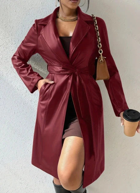 Women's long sleeve faux leather trench coat in various colors with pockets and slim fit design