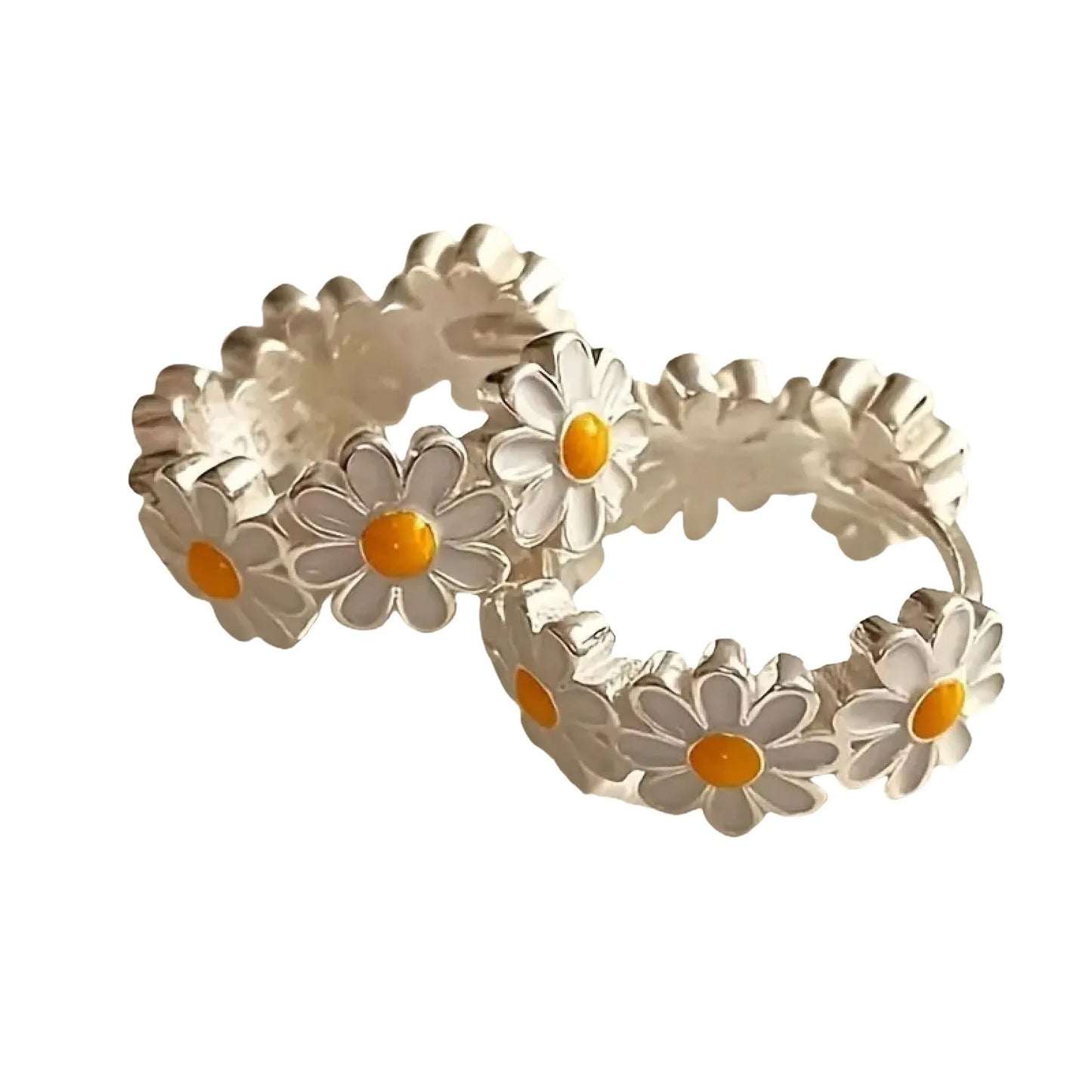 A pair of white daisy flower ring earrings with an inlaid gemstone in a platinum setting.