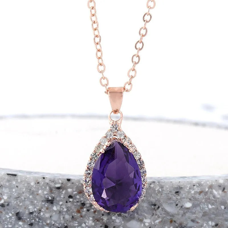 Rose gold geometric water drop pendant necklace on a model, showing adjustable chain and sparkling stone inlay.