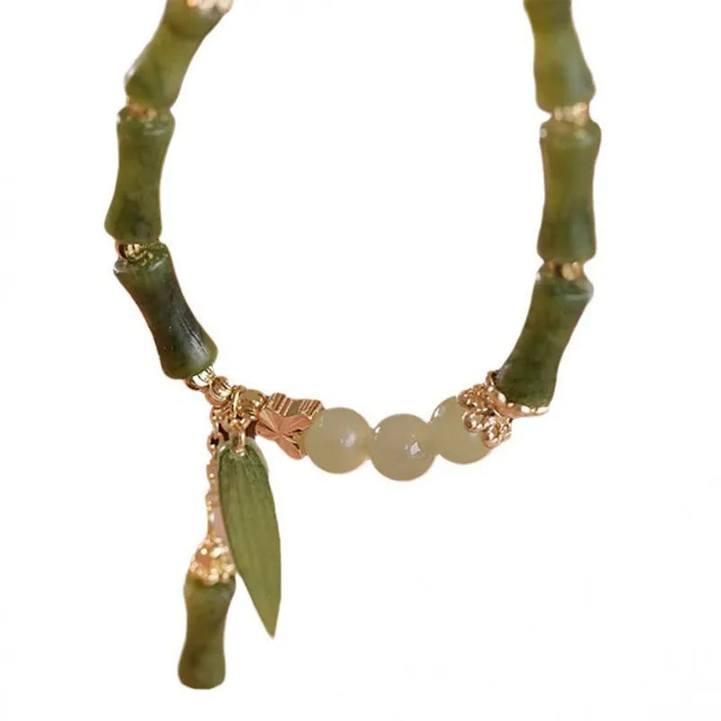 Chinese style glass bead bracelet with bamboo joint design on wrist.