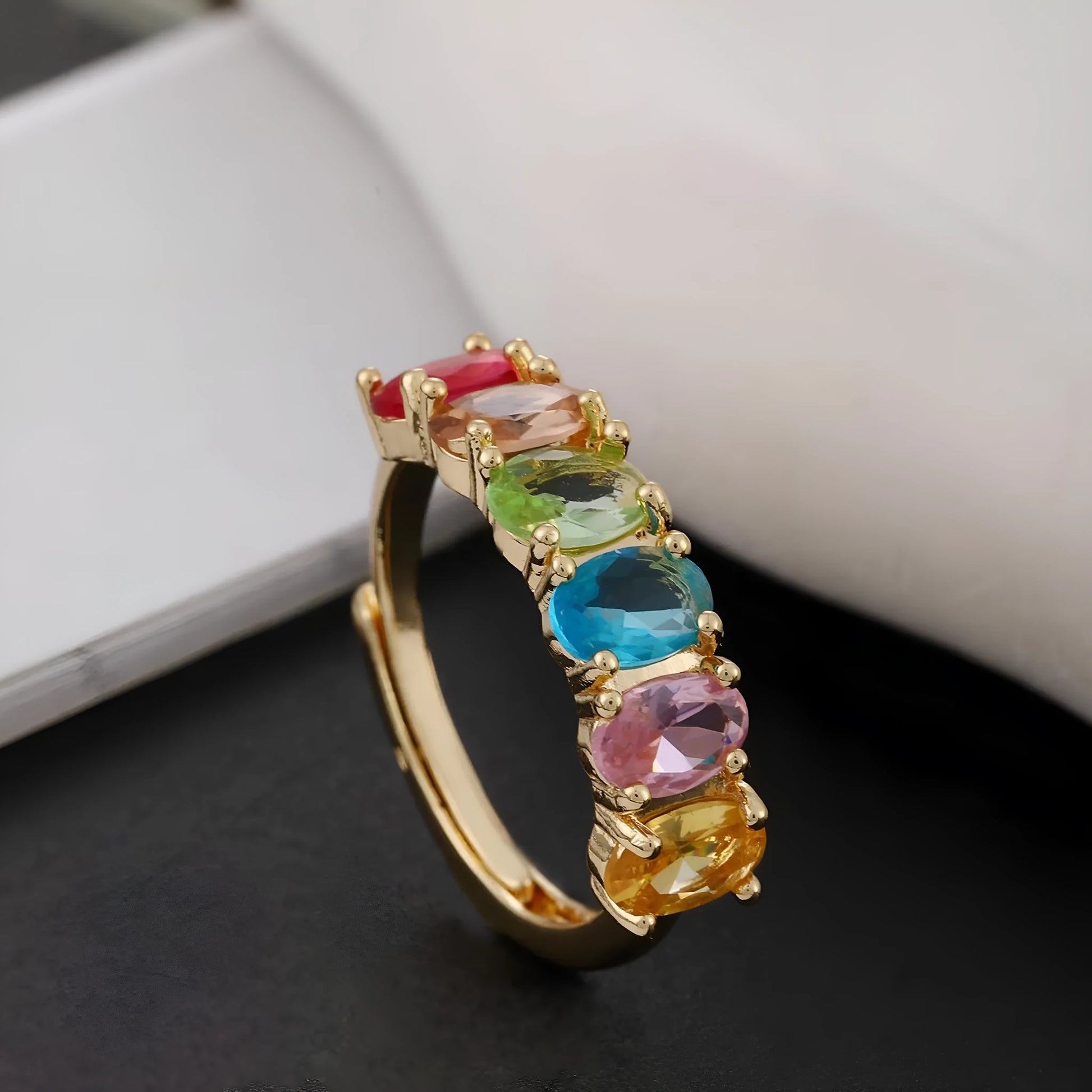 Gold electroplated adjustable open band zircon ring on white background