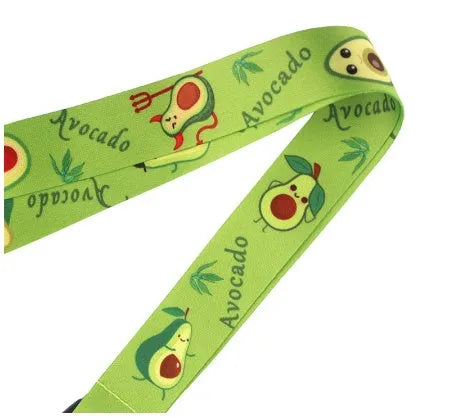 Green avocado cartoon print on a white polyester phone lanyard with a silver buckle.
