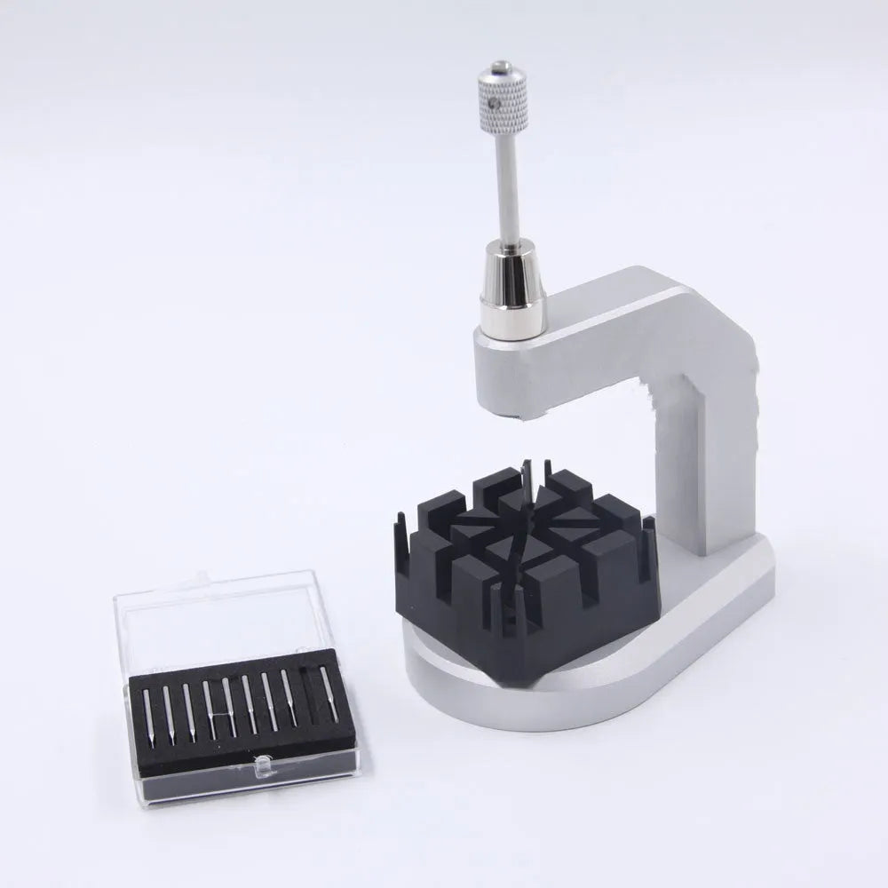 Silver multi-purpose press strap removal tool made from tool steel.