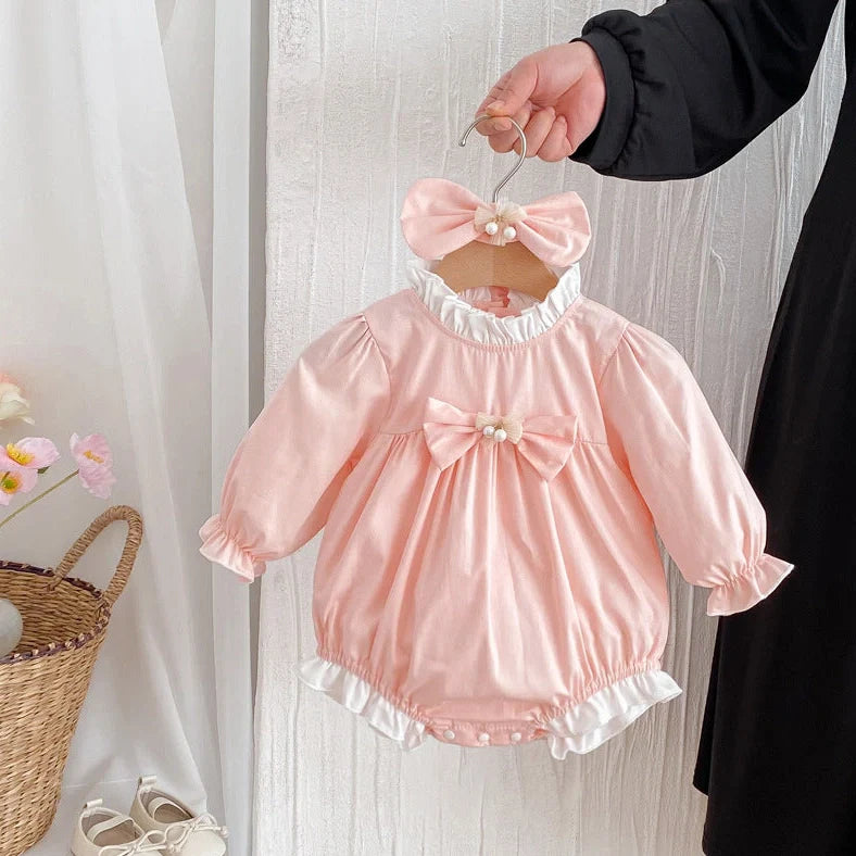 Girl wearing peach branch climbing colour triangle jumpsuit with princess dress styling and matching headband