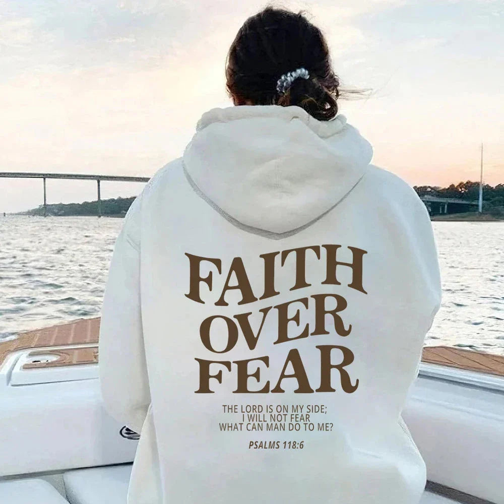 A stylish Christian hoodie with inspirational graphics and a message of faith over fear