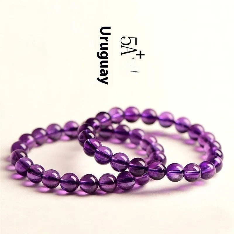 Natural amethyst scattered beads bracelet from Uruguay showing purple crystal beads in various sizes from 4mm to 16mm diameter
