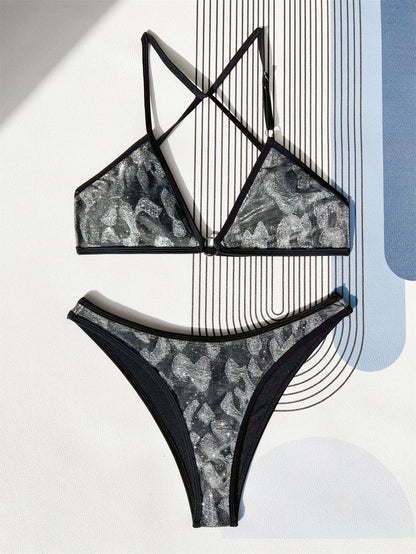 Women's black polyester bikini swimsuit with adjustable straps laid flat