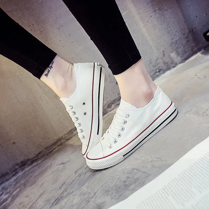 Women's solid-colour canvas lace-up shoes in black, shown on a neutral background.