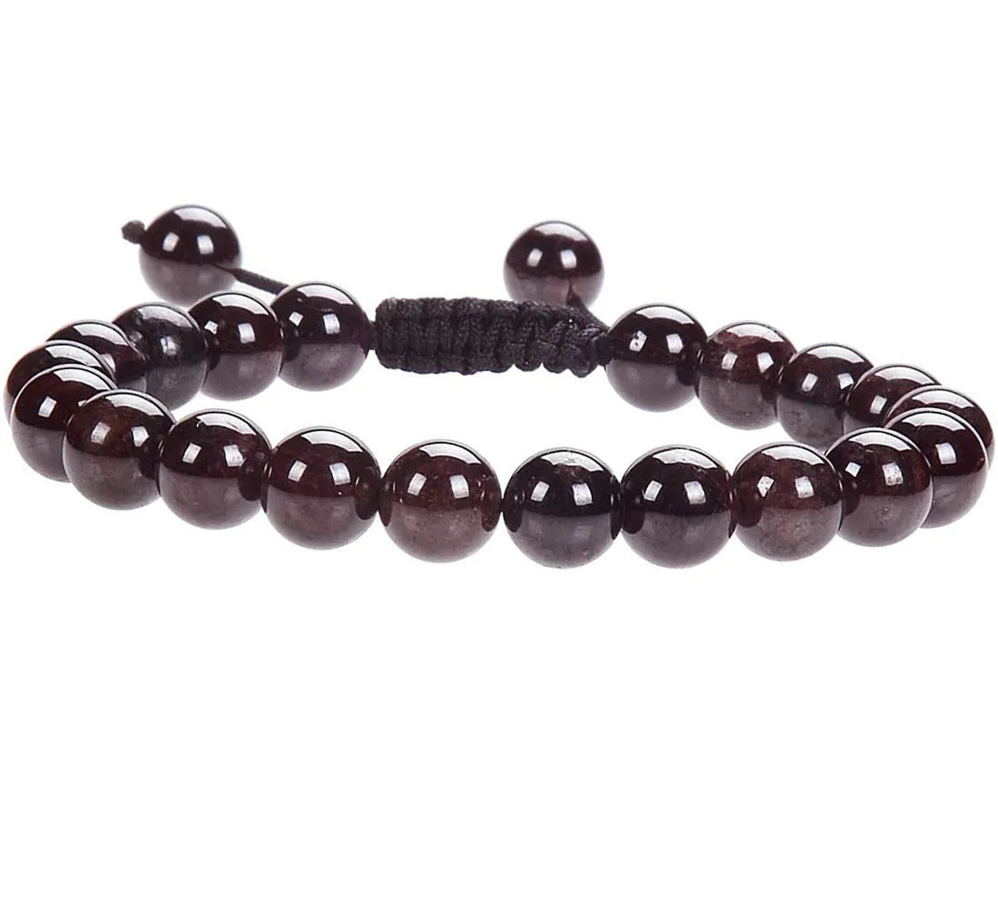 Close-up of a women's flat knot braided healing bracelet hand-woven with colourful gemstones.