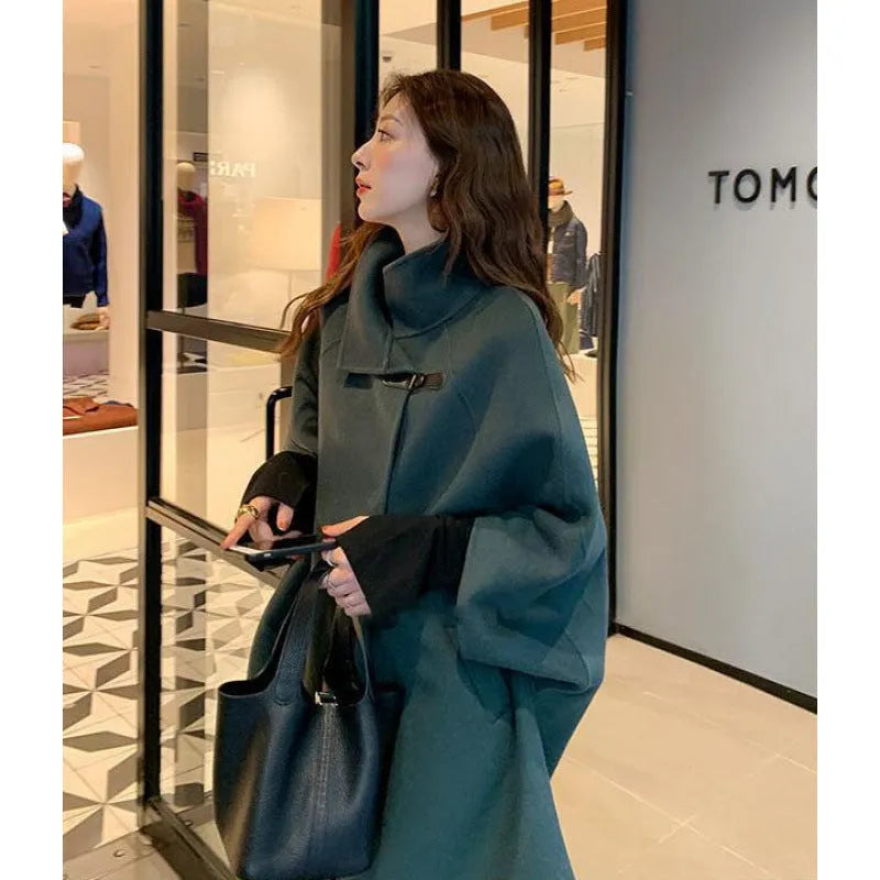 Long-length women's Korean-style acrylic coat in oatmeal colour with flight sleeves.