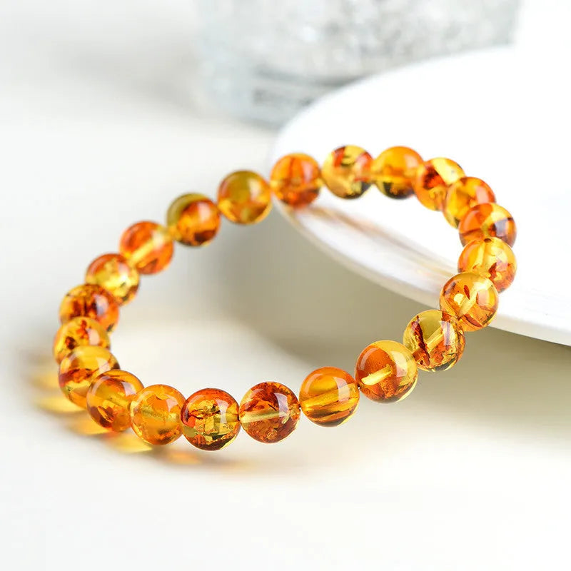 Natural yellow piebald amber bracelet with 7-10mm geometric beads on wrist