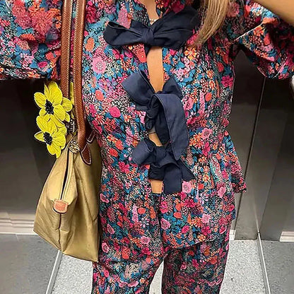 Floral print trousers suit with puff sleeves and tie-neck top in picture colour