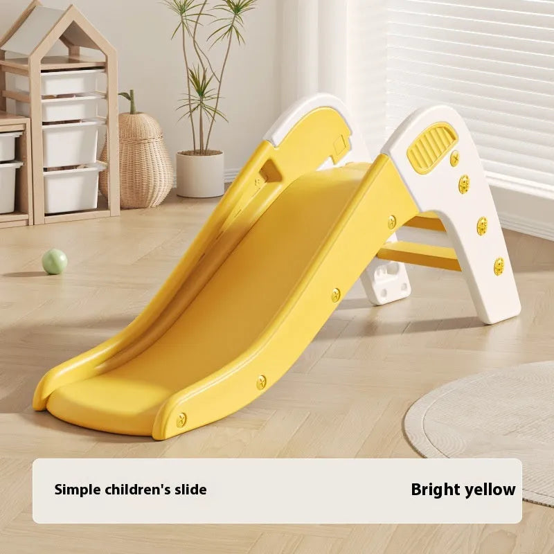 Small blue plastic baby slide for toddlers in a garden setting.