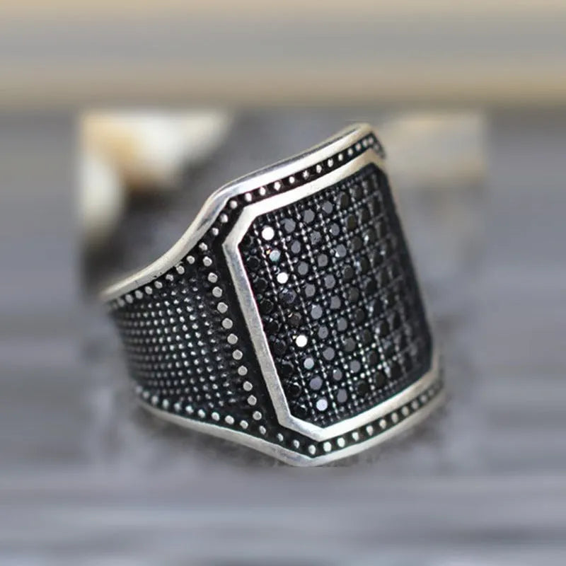 Black alloy ring with copper inlays and zircon accents, shown in a unisex style on a hand, sizes 7-13 available