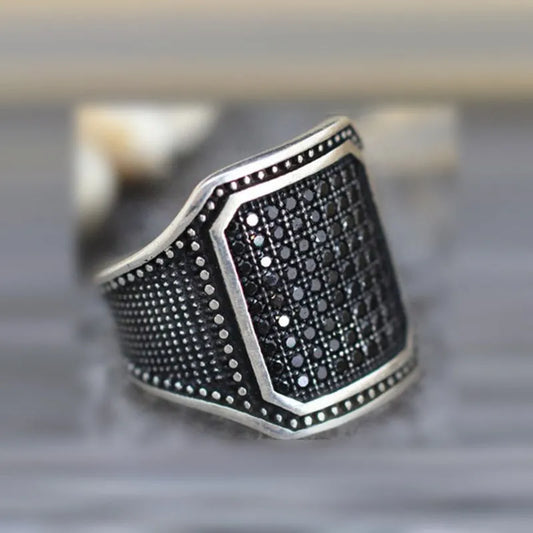 Black alloy ring with copper inlays and zircon accents, shown in a unisex style on a hand, sizes 7-13 available