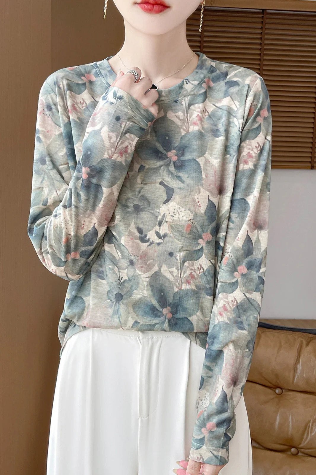 Round neck floral print pullover shirt in Tencel cotton blend fabric on hanger