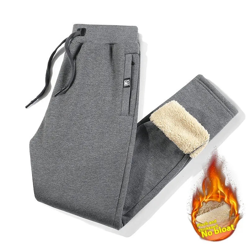 Grey fleece-lined men's cotton track pants with a drawstring waist shown in an oversized fit.