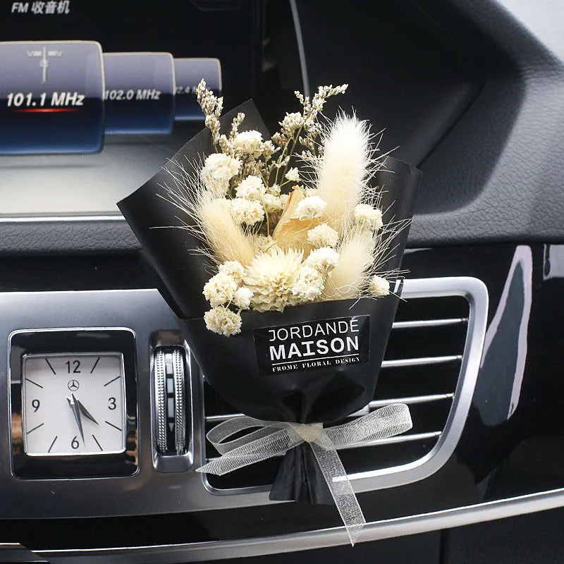 Mini dried flower bouquet mounted in car air vent for decorative aromatherapy
