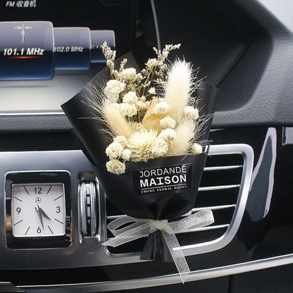 Mini dried flower bouquet mounted in car air vent for decorative aromatherapy