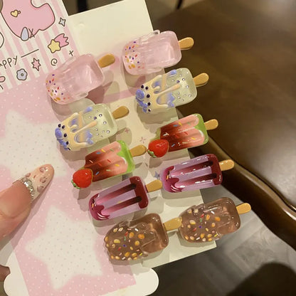 A resin hair barrette with a cartoon ice cream charm on a side-clip, shown in a pink colour variant.