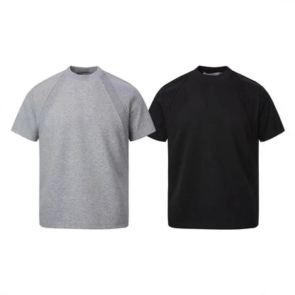 Man's loose fit black short sleeve top with textured air layer stitching detail.