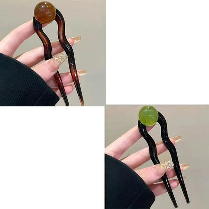 Acrylic U-shaped hair barrette with retro ball design in caramel colour