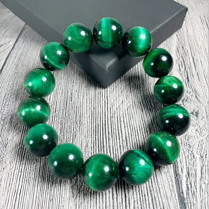 Green Tiger Eye stone bracelet with geometric beads, showing size options.