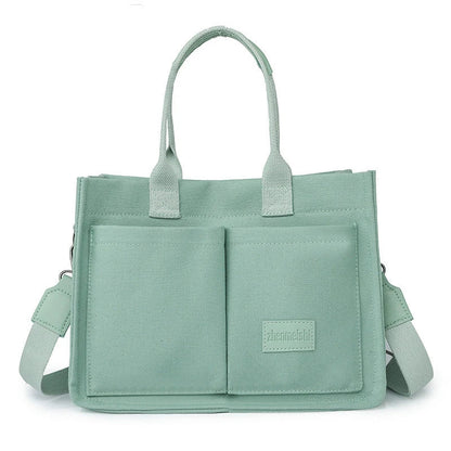 Premium canvas tote bag in multiple colors with adjustable shoulder strap and organizational pockets