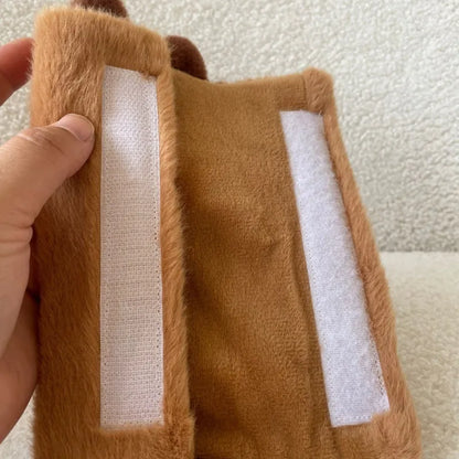 Khaki capybara car pillow in artificial plush with synthetic fibre filling, shown as a car neck pillow or shoulder cover.