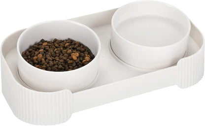 Green ceramic raised cat feeder with two tilted bowls on a non-slip white stand.