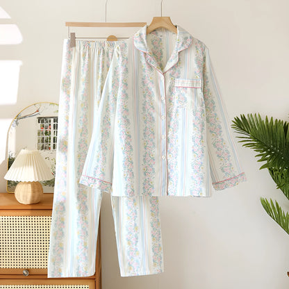 Red fruit print cotton gauze ladies' pyjama set with long sleeves and trousers laid flat.