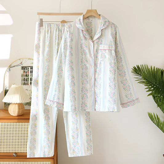 Red fruit print cotton gauze ladies' pyjama set with long sleeves and trousers laid flat.