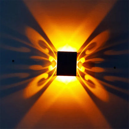 Modern aluminium butterfly-shaped LED wall lamp with remote control for colour changing.