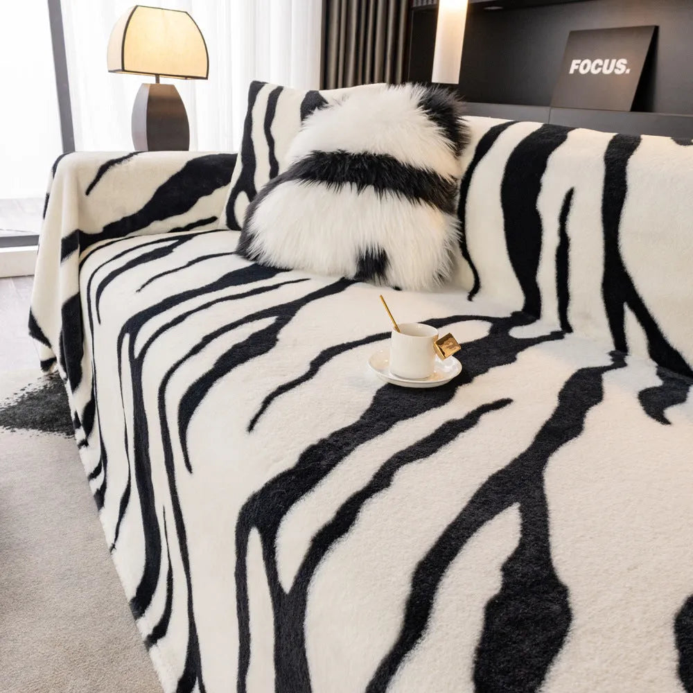 Zebra pattern sofa cover cloth in flannel fabric with non-slip backing, shown in caramel colour on a sofa