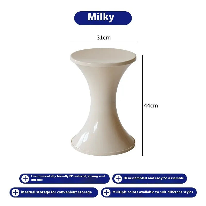 Plastic hourglass-shaped shoe changing stool in green, 40cm high and 30cm wide