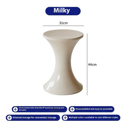 Plastic hourglass-shaped shoe changing stool in green, 40cm high and 30cm wide