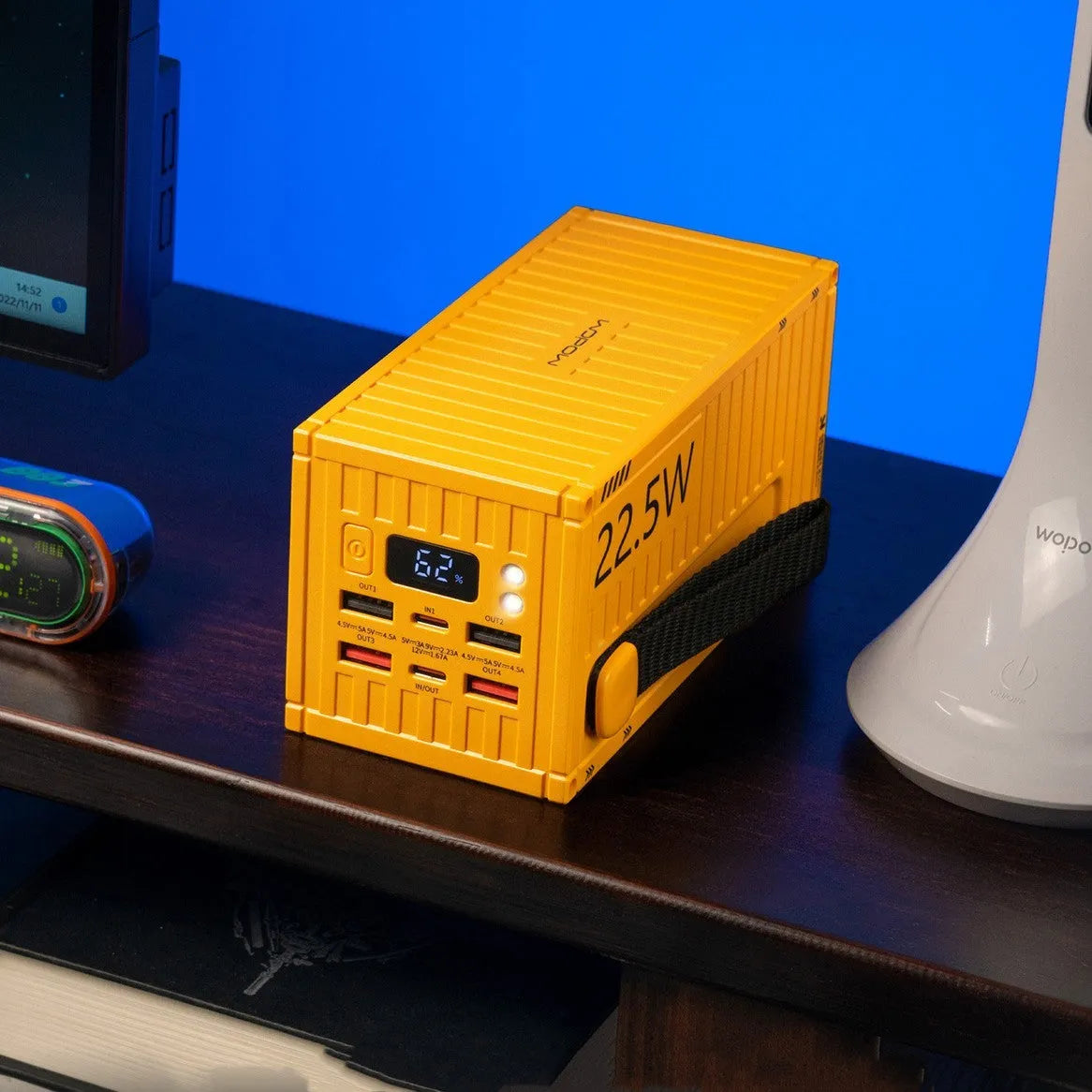 Yellow 50000mAh portable power bank with digital display showing battery percentage and multiple USB ports.