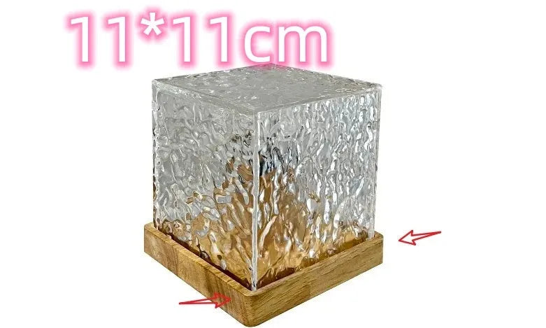 LED water ripple projection night light with remote control on wooden base showing colourful light patterns