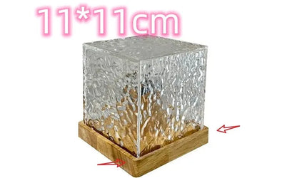 LED water ripple projection night light with remote control on wooden base showing colourful light patterns